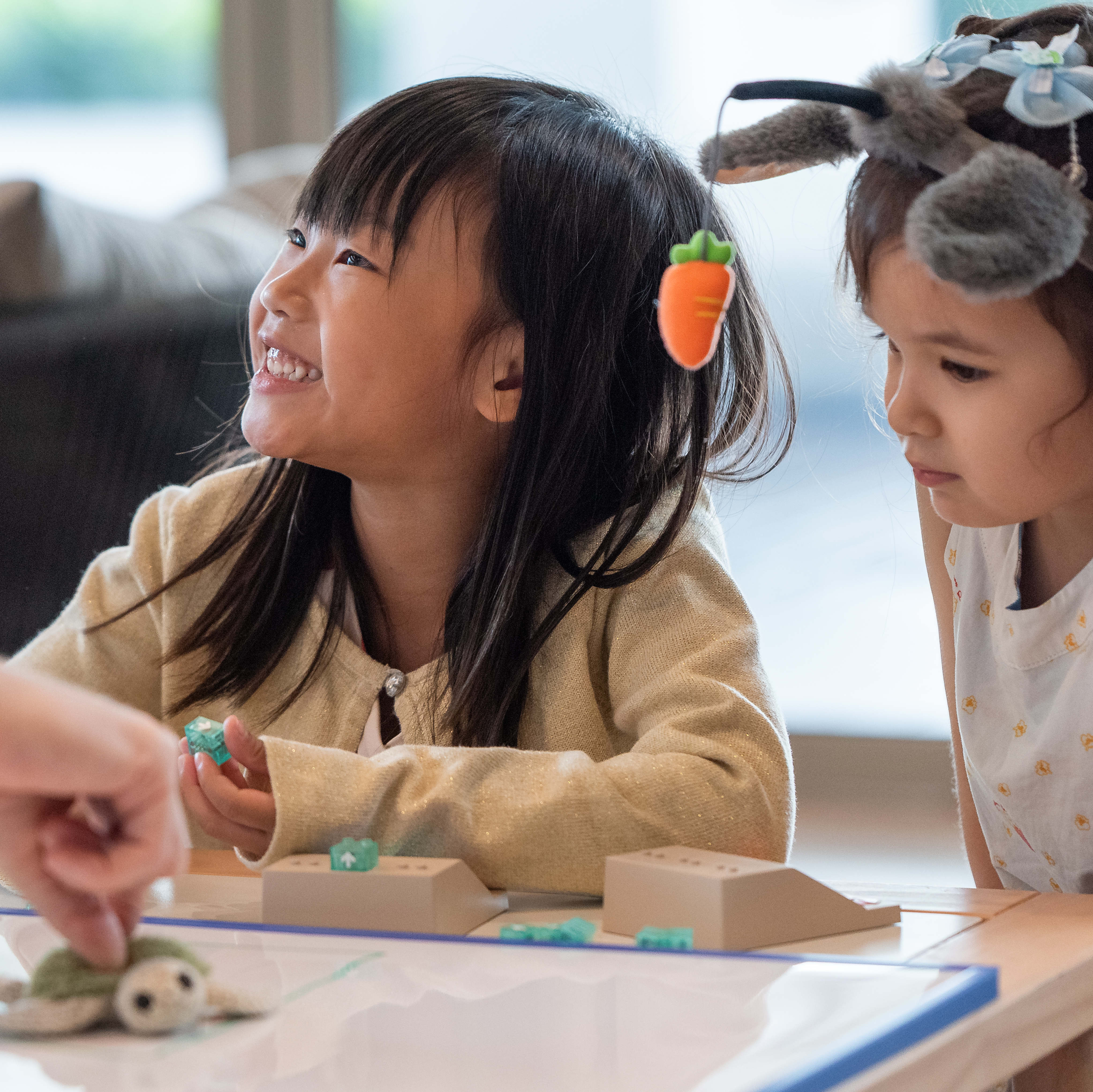 Children at a DrBartha hands-on coding workshop, building programs with magnetic bricks